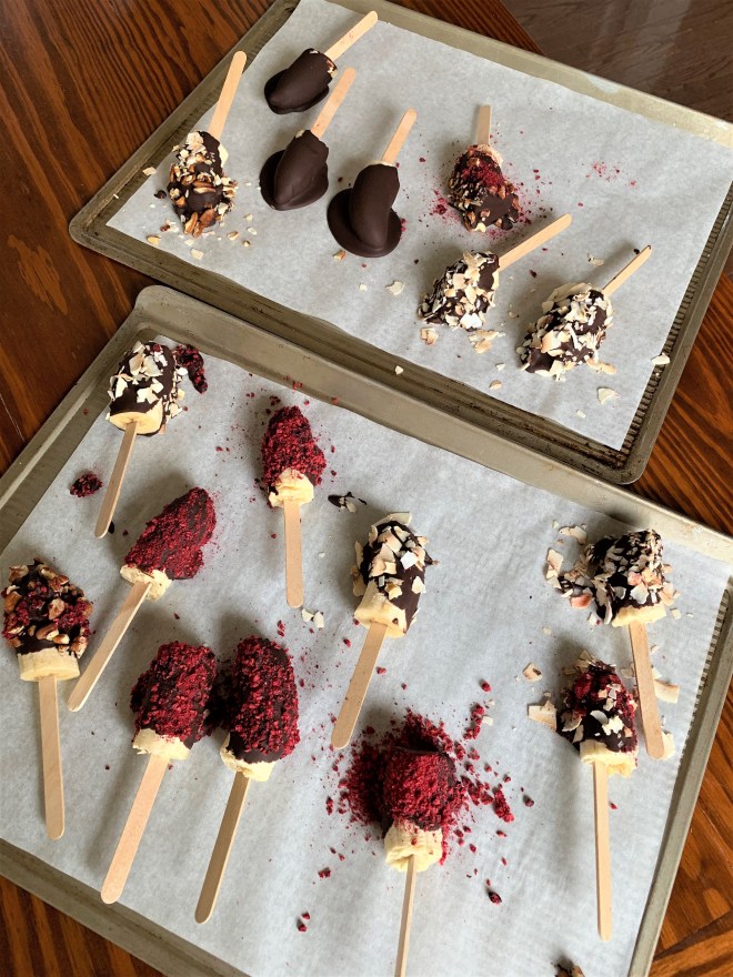 Chocolate Dipped Banana Pops on a cookie sheet
